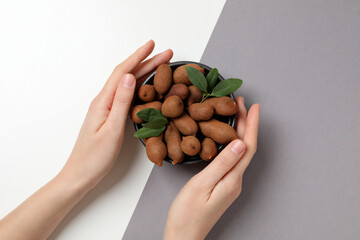 Wall Mural - Ripe tamarind with leaves in a wooden bowl