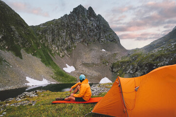Wall Mural - man hiking solo with camping gear tent tourist sitting on sleeping pad - travel adventure healthy li