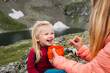 © EVERST - Family picnic - сhild eating camping food outdoor in mountains - travel together mother feeding baby hiking together tourism adventure summer vacations