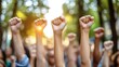 © Garin - A group of people raising their fists in solidarity during a protest or demonstration.