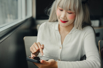Poster - woman with light hair using smartphone in cozy setting