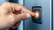 © JK_kyoto - hand pressing button on device, activating light
