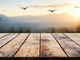 Poster - Empty wooden table with blurred mountain background at sunset