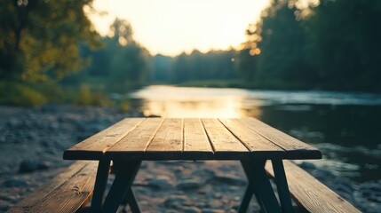 Poster - Wooden picnic table inviting to relax by the river at sunset