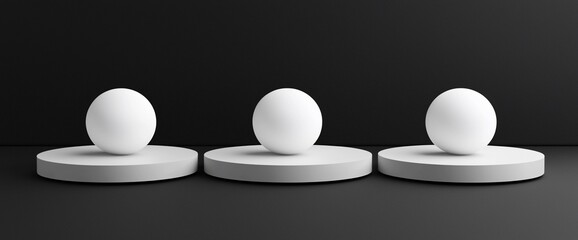 Aufkleber - Three white spheres on grey cylindrical bases against a black background.