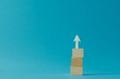 © Infinity Gallery - Wooden block stacking as step stair with white arrow up on blue background, Ladder of success in business growth concept, copy space, Generative AI
