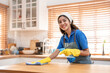 © Kawee - Portrait of Asian cleaning service woman worker working in the kitchen.