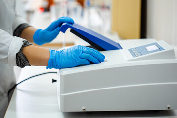 Poster - laboratory technician operates scientific equipment for research in a clinical setting during daytim