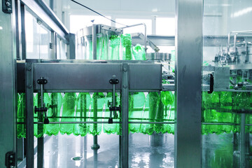 Poster - bottling process of green soda in a modern beverage production facility in an industrial setting