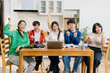 © NINENII - Group of students with books preparing for exams during holidays.