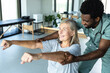 © zinkevych - Man chiropractor assisting adult woman patient with pain relief and recovery through rehabilitation