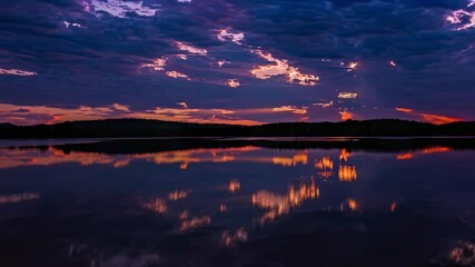 Fototapete - Beautiful sunset reflections over serene lake with vibrant colors in the sky and calm water