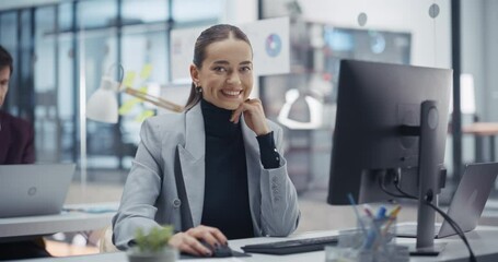 Aufkleber - Beautiful Female Manager Using Desktop Computer while Sitting Behind a Desk in the Office. Portrait of a Young Caucasian Woman Posing, Smiling and Looking Confidently at Camera