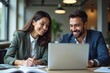 © Fazla - Happy Professional Business Man and Woman Working on a Laptop at an Office Meeting, Two Busy Colleagues Collaborating and Discussing a Business Plan Together. Generative AI