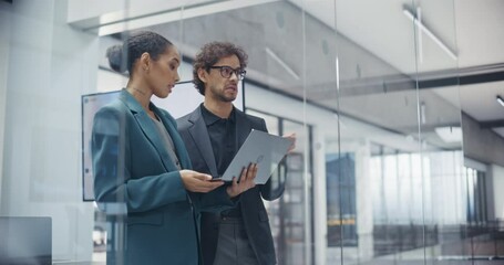 Aufkleber - Two Corporate Professionals Having a Conversation in Office, Standing in a Meeting Room, Using Laptop Computer to Analyze Market Trends. Black Female and Latin Male Discuss Sales and Market Share