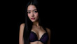 © Evgenii Starkov - Elegant portrait of a woman with long black hair and bangs, wearing black lingerie against a dark background.