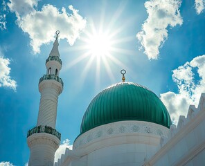 The green dome of the historic Nguyen Minaret and white walls of Masjid al-Nabawi in Mecca, stock photo with blue sky and clouds in the background. 