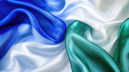 Poster - Elegant blue white and green sheer silk fabric draped gracefully displaying smooth texture and vibrant color transitions on a soft background