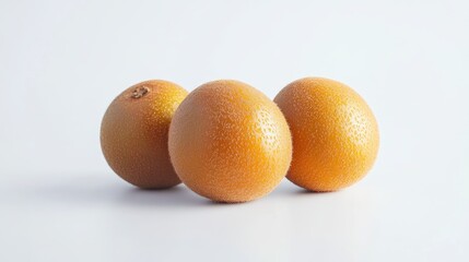 Aufkleber - Three Vibrant Orange Kiwi Fruits on a Light Background with Ample Copy Space for Text or Branding Elements