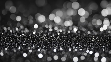 Poster - Silver glitter on a black background with an abstract bokeh effect creating a shimmering and elegant visual texture.