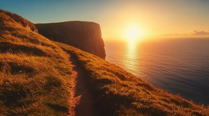 Aufkleber - Serene coastal trail along a cliff edge at sunrise with golden grasses and tranquil sea view illuminated by warm morning light