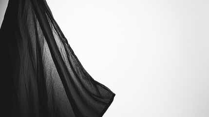 Poster - black sheer fabric flowing with softbox lighting on a clean white photography backdrop in a minimali