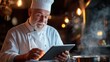© SerPhoto - Senior chef checks recipe podcast on tablet while cooking in a cozy restaurant kitchen