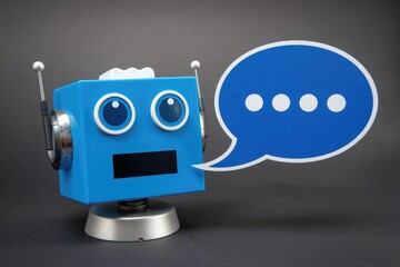 Poster - A blue robot with antennas speaks using a speech bubble; communication and AI concept.