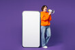 © ViDi Studio - Full body young fun woman she wear orange hoody casual clothes big huge blank screen mobile cell phone smartphone with area scream in megaphone isolated on plain purple background. Lifestyle concept.