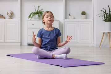 Sticker - Cute little girl exercising on fitness mat indoors