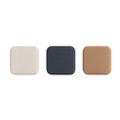 © kiimoshi - Three colorful square coasters in shades of beige, navy, and brown on a white background.
