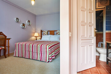 Wall Mural - Old hotel room interior style with bed mirror carpet design.