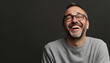 © Ch - Portrait of a laughing man with stubble wearing a grey sweatshirt and glasses