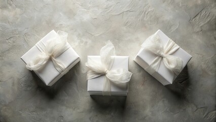 Wall Mural - Three elegantly wrapped presents with sheer white ribbons, arranged on a textured surface