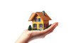 © PERFECTisME - a small. colorful model house resting on an open palm. symbolizing the concept of home ownership and real estate the hand represents care and protection. emphasizing the importance of housing in perso