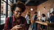 © fotofabrika - Smiling woman with glasses enjoys coffee while using smartphone in a bustling cafe during daytime