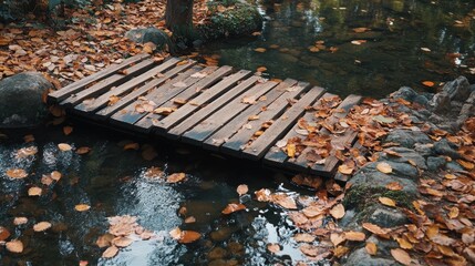 Poster - Small wooden bridge crossing a tranquil stream surrounded by autumn leaves in a serene natural setting