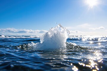 Poster - Ice formation in ocean under clear blue sky with bright sunlight reflecting on the water surface