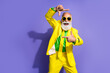 © deagreez - Photo of elegant charismatic aged man cadre gesture empty space yellow suit isolated on violet color background