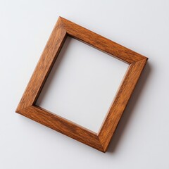 Poster - Polished wooden picture frame resting on a light-colored surface with a simple design