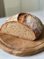 Aufkleber - Rustic loaf of bread on a wooden cutting board captured in a bright kitchen setting