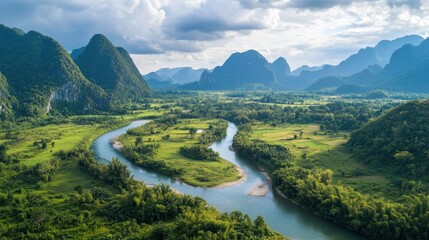Poster - Serene river winding through lush green landscape with mountains in the background and dramatic cloudy sky