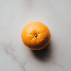 Poster - Ripe orange with smooth peel resting on a light marble surface ready for consumption or cooking