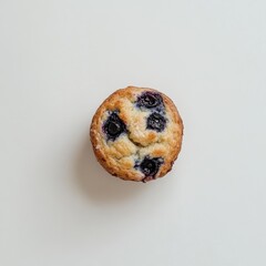 Poster - Freshly baked blueberry muffin resting on a plain surface ready to be enjoyed for breakfast or as a snack