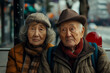 © PhotoProAD - Two elderly people sitting on a bench, one wearing a hat and scarf