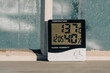 © OlegD - Electronic device to check temperature and humidity in closed area near window in winter sunny day, closeup