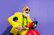 © deagreez - Photo of cool funny man wearing yellow trendy costume riding motorbike hurrying empty space isolated on purple color background