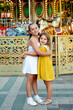 © Any Grant - children in the amusement park and attractions, happy children hug and enjoy the holidays and summer, two girls came to the carousel
