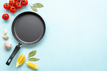 Wall Mural - Cooking concept - empty frying pan with spices on the kitchen desk top