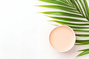 Poster - flat lay composition of a green tropical palm leaf and a round container with light peach-toned liqu
